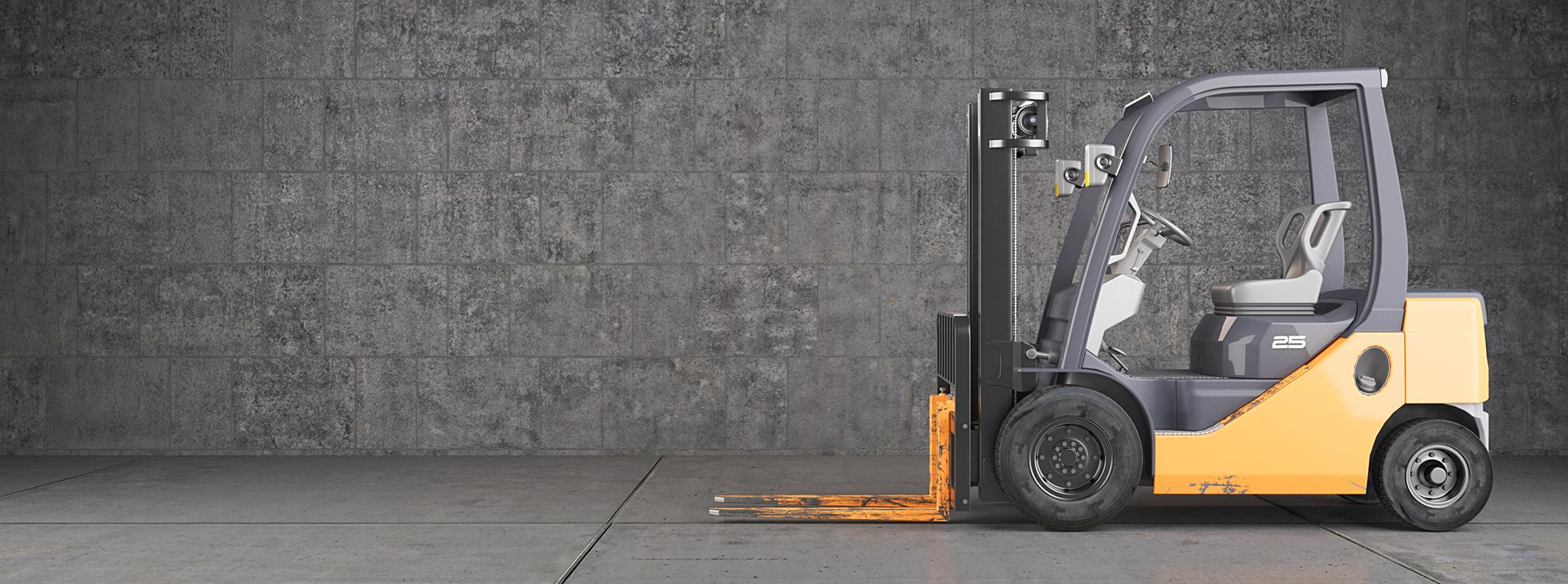 Forklift truck standing on industrial concrete wall background